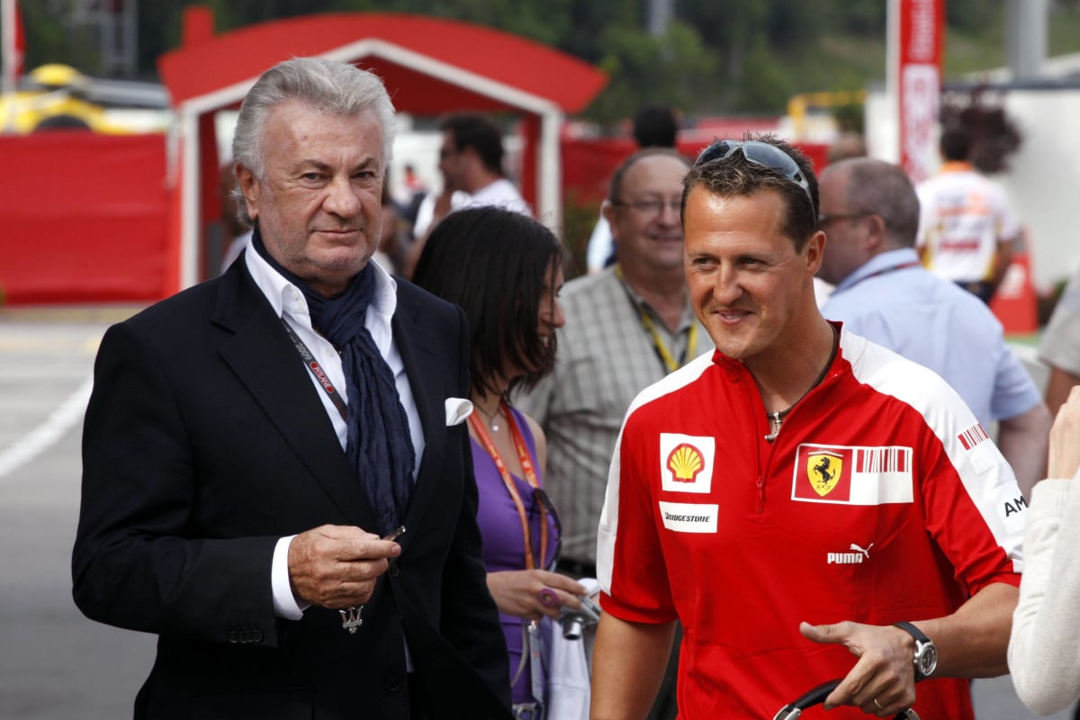 Michael Schumacher and manager Willi Weber discuss matters at the 2009 Spanish Grand Prix