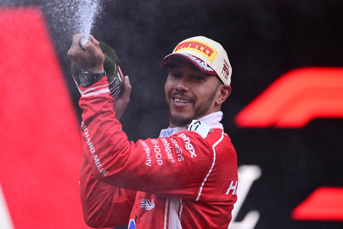 Lewis Hamilton sprays champagne on the F1 podium
