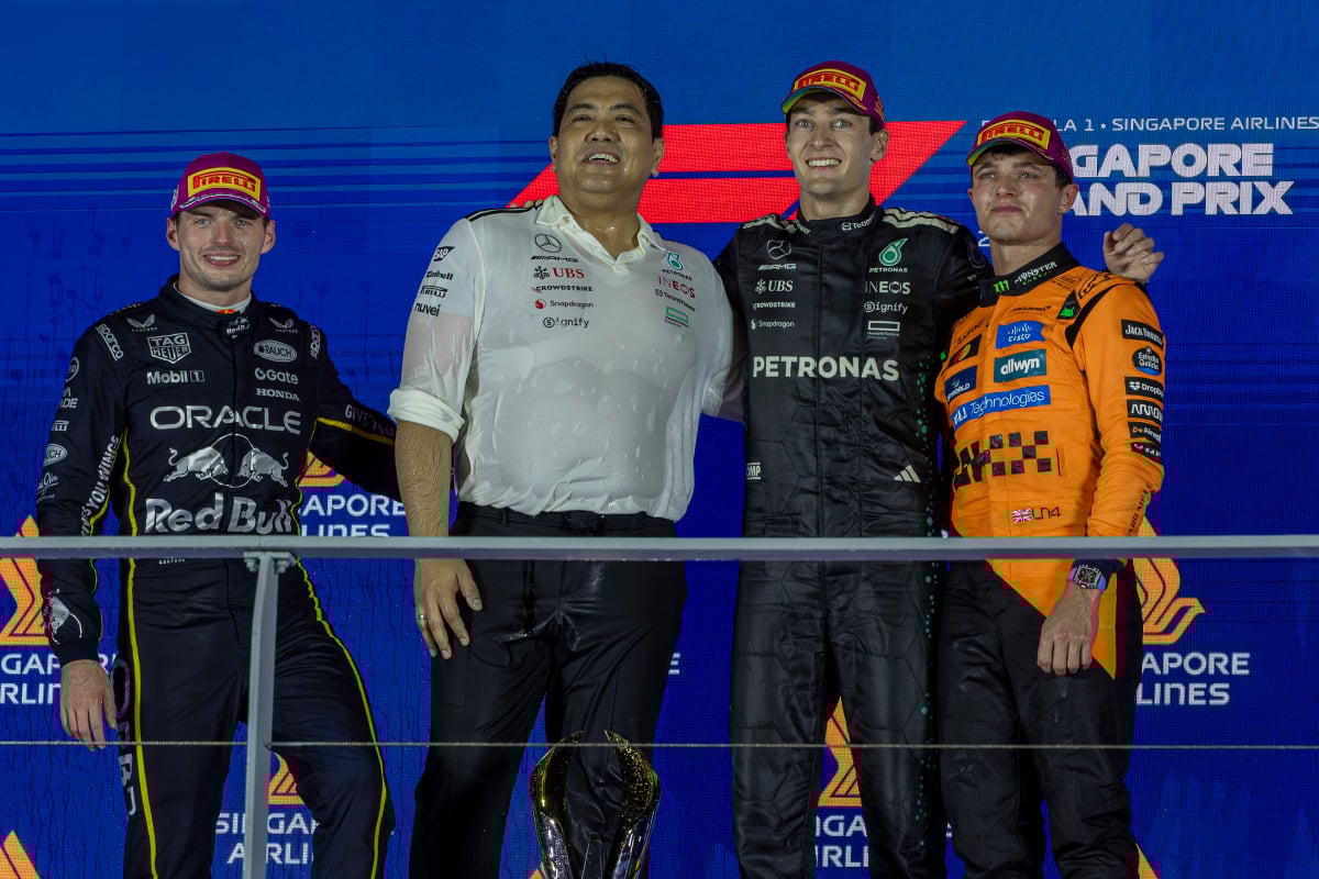 George Russell, Max Verstappen and Lando Norris stand on the Singapore Grand Prix podium 2025