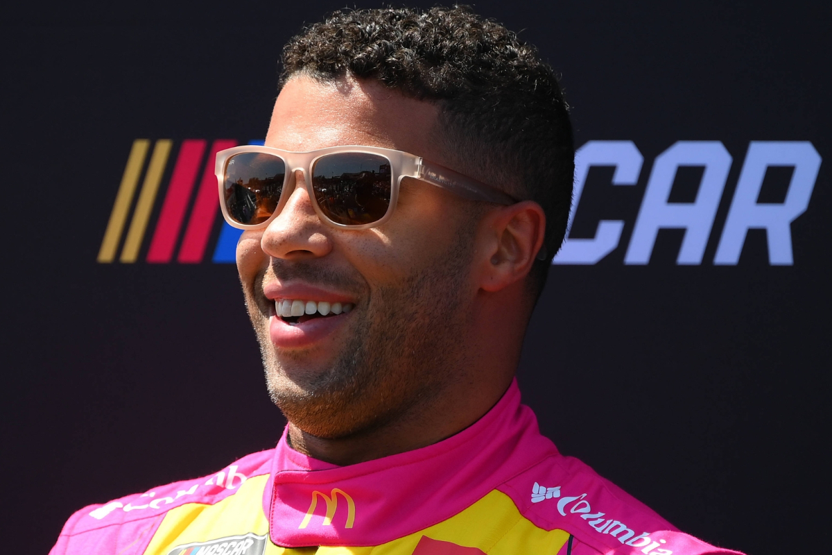An image of NASCAR driver Bubba Wallace with a big smile