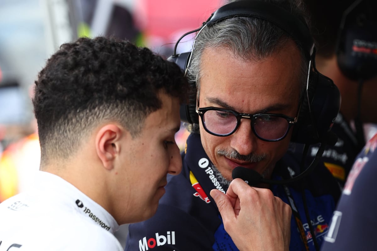 Mekies sat at the Red Bull F1 pit wall talking into Hadjar's ear