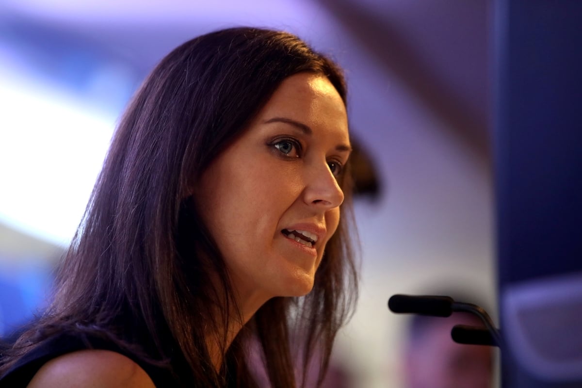 Lee McKenzie speaking into a microphone