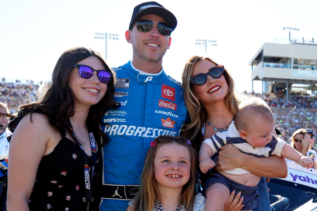 An image of Joe Gibbs Racing driver and 23XI owner Denny Hamlin with his wife and children