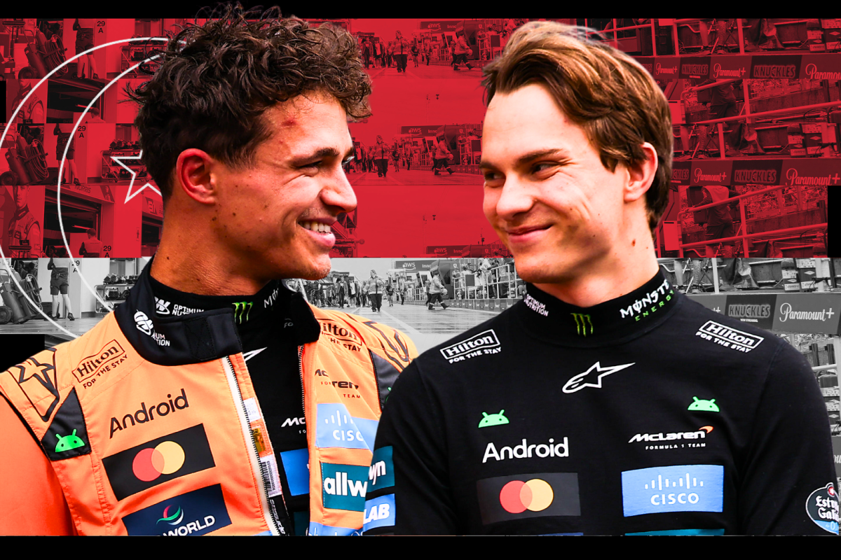 Norris and Piastri smiling in front of Singapore flag background