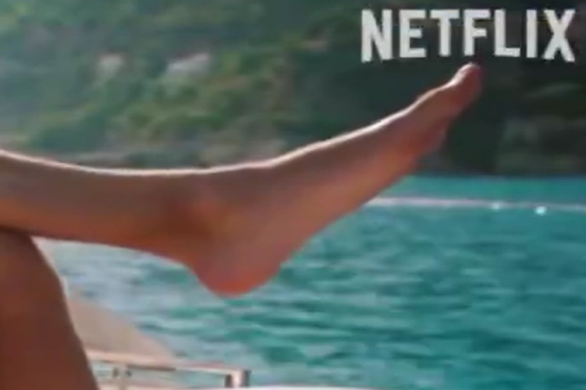 Screenshot from the DTS trailer of Russell's huge foot hanging over a boat, nearly taking up the whole screen with Netflix logo top right