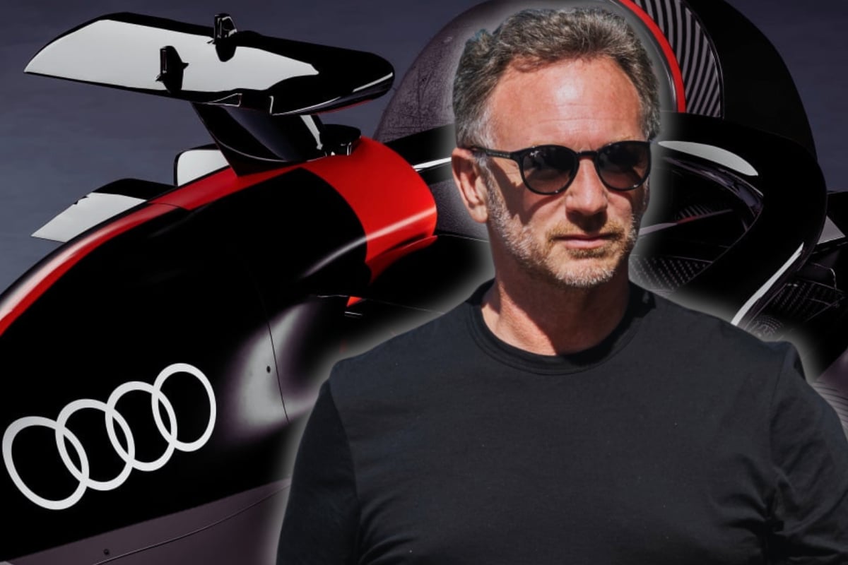 Horner in black t-shirt and sunglasses with background of Audi F1 car close-up