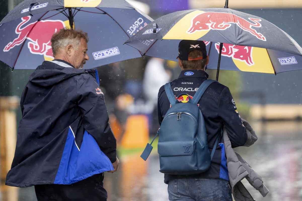 An image of Red Bull star Max Verstappen under an umbrella at a rainy Dutch Grand Prix in 2026