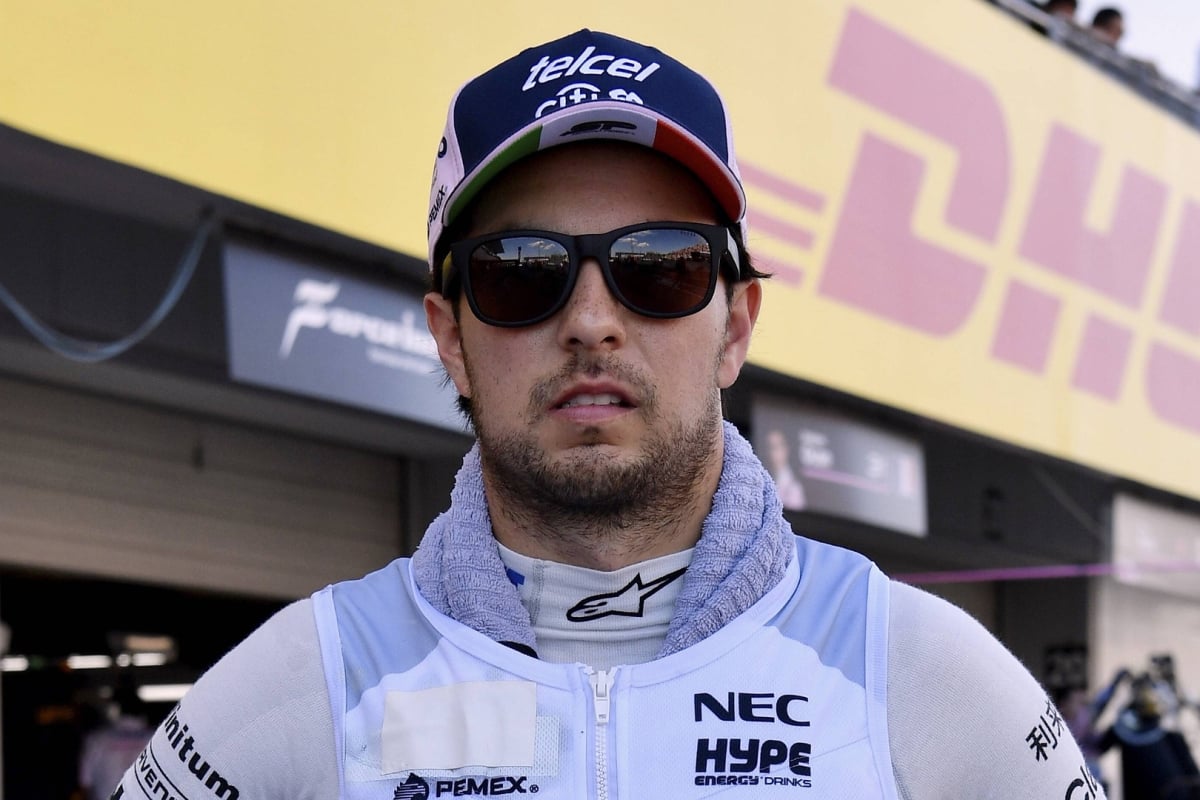 Force India's Sergio Perez stands in the Suzuka pits in 2018