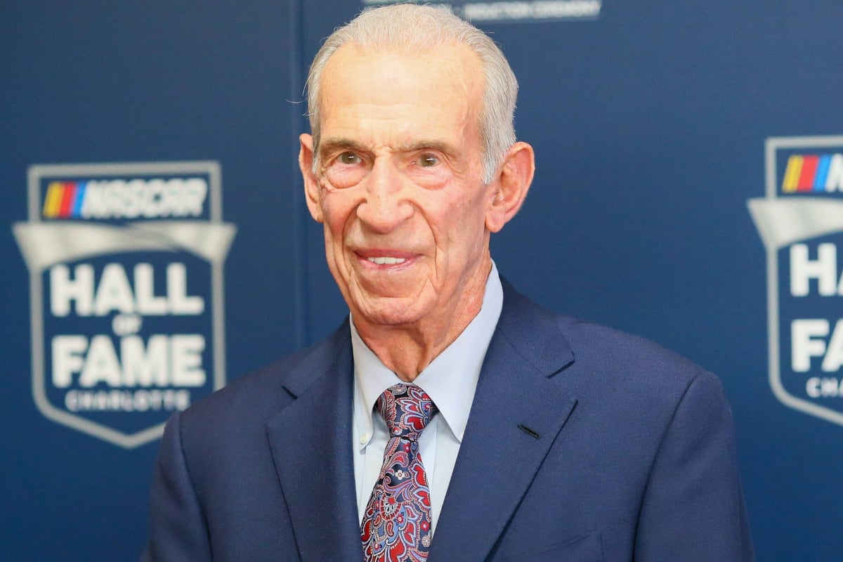 An image of NASCAR champion and Hall of Famer Ned Jarrett smiling at a ceremony