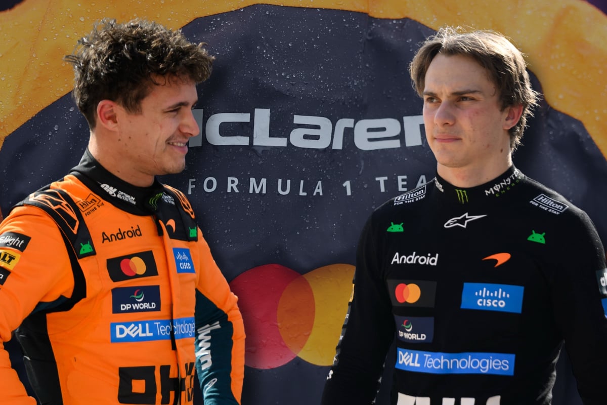 Lando Norris and Oscar Piastri look at each other with a McLaren logo background