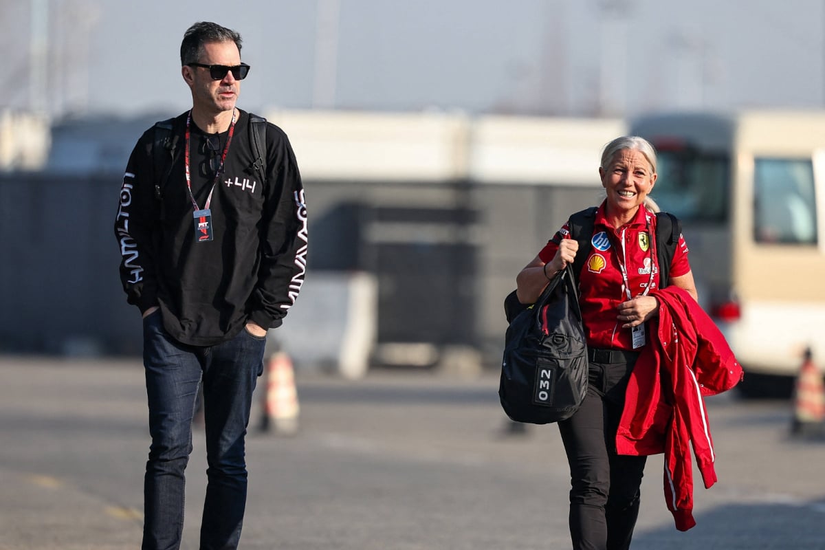 Hynes and Cullen walking through Chinese GP car park together, Hynes in black clothing, Cullen in Ferrari kit