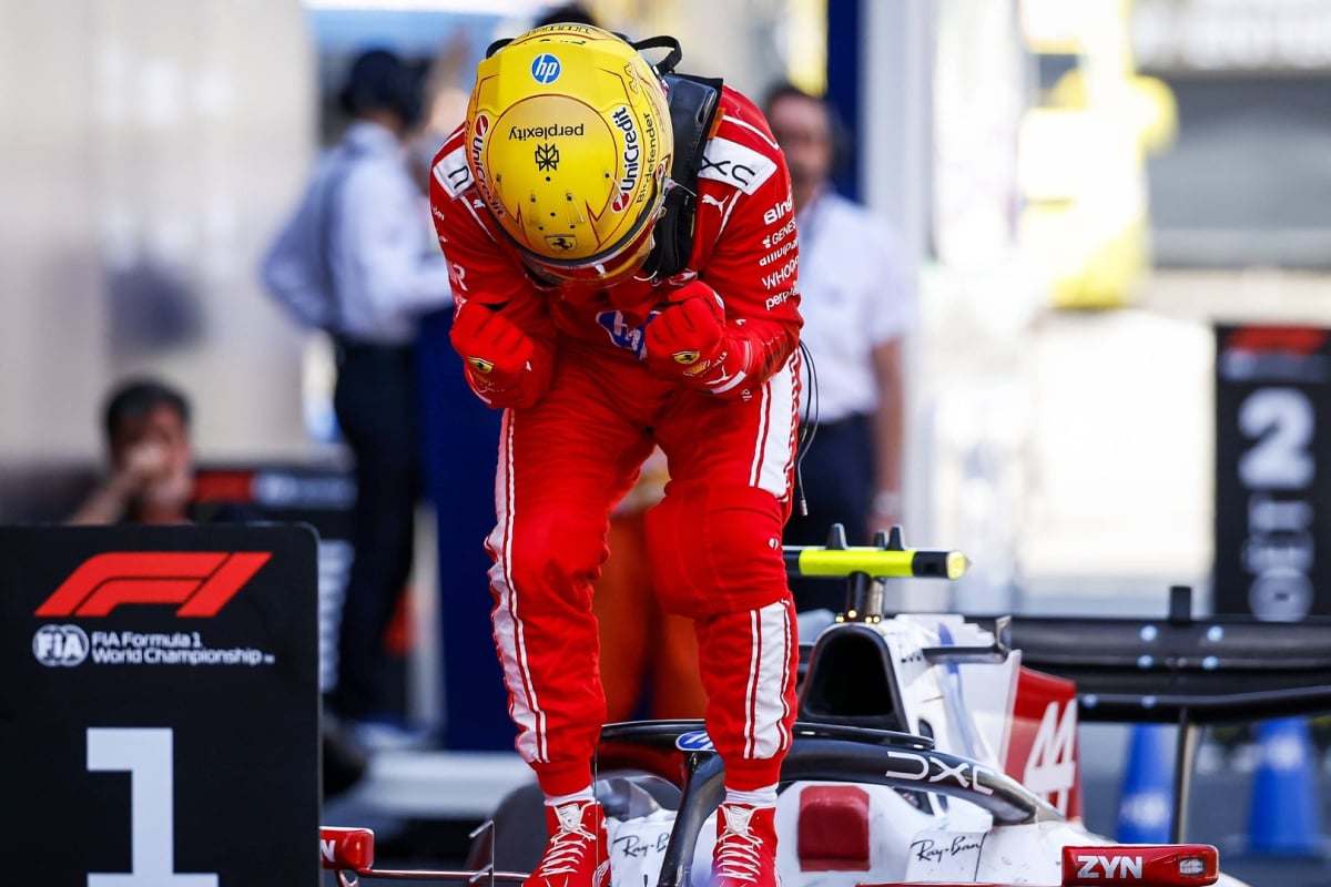 Lewis hamilton celebrates next to a P1 at the Barcelona GP