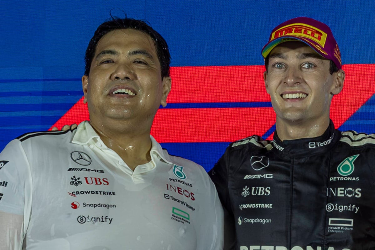 George Russell and Tengku, Muhammad Taufik Tengku Aziz celebrate on the Singapore Grand Prix podium 2025