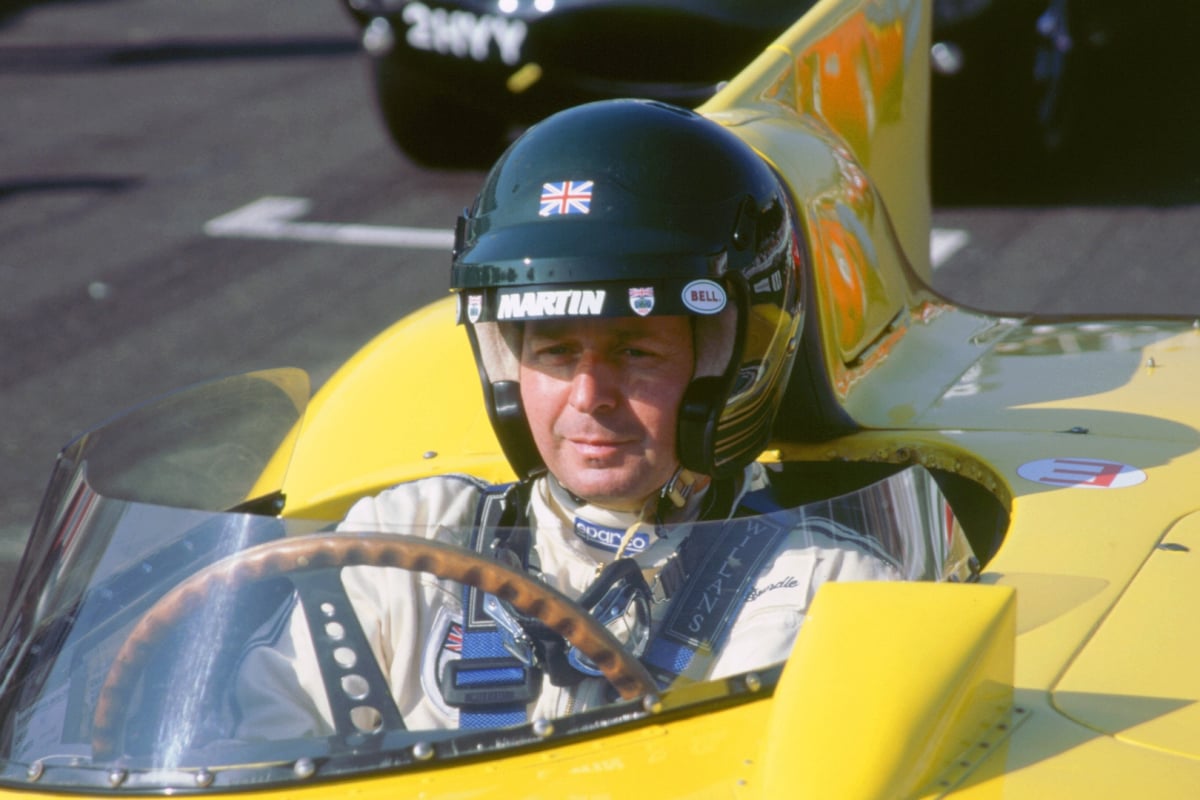 Martin Brundle at the wheel of a retro car at Goodwood Revival