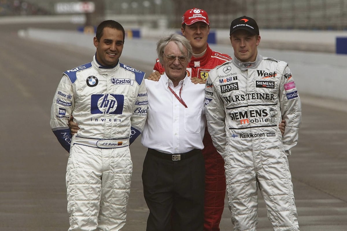 Michael Schumacher, Bernie Ecclestone, Kimi Raikkonen, Juan Pablo Montoya stand ahead of the 2003 US Grand Prix
