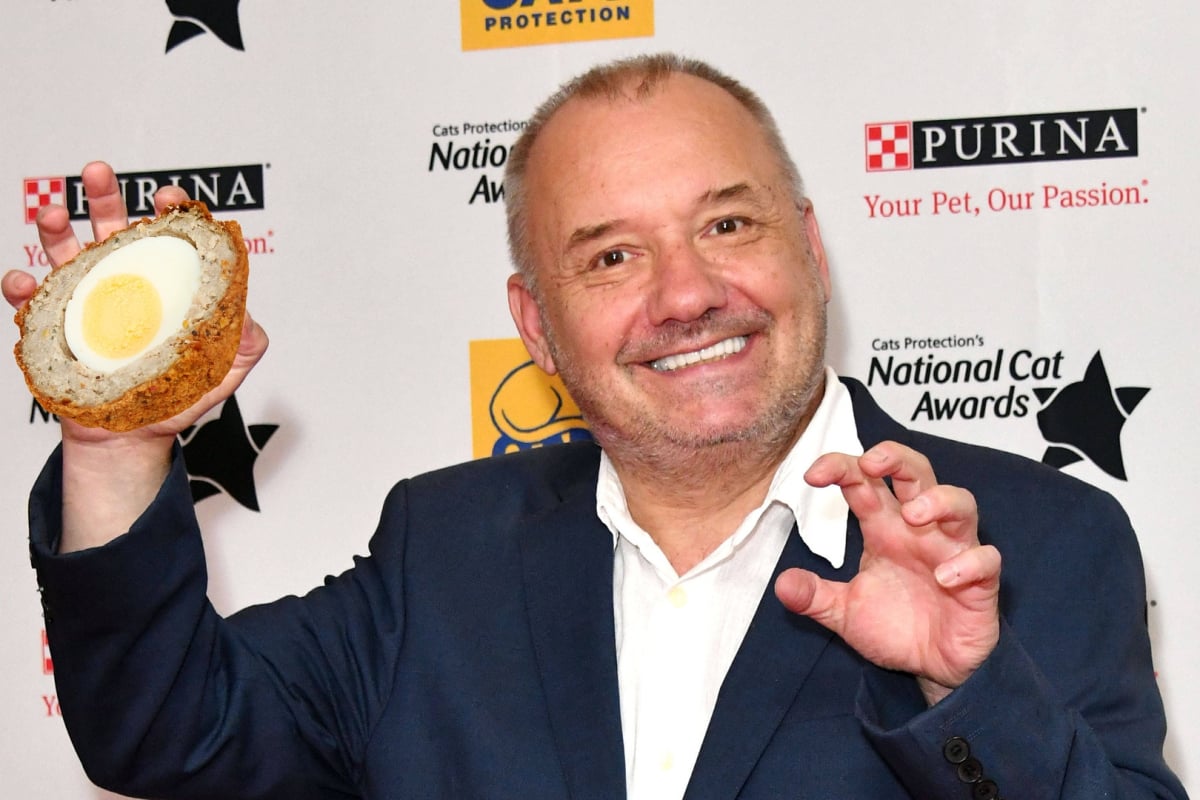 Bob Mortimer posing as a cat with a scotch egg edited in his grasp