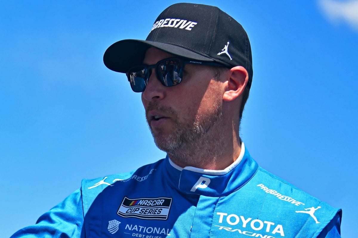 An image of NASCAR star Denny Hamlin signing autographs at a race weekend