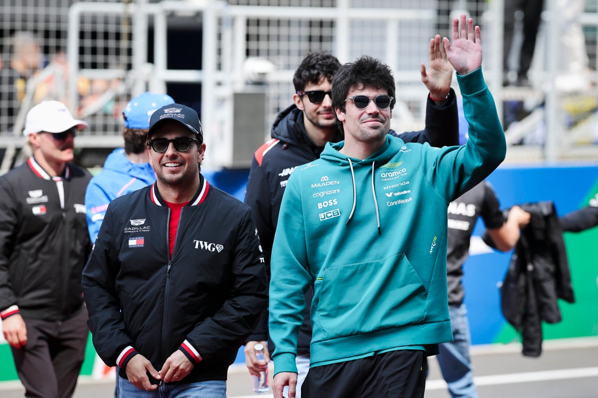 Lance Stroll and Sergio Perez smile and wave at the fans at the Chinese GP