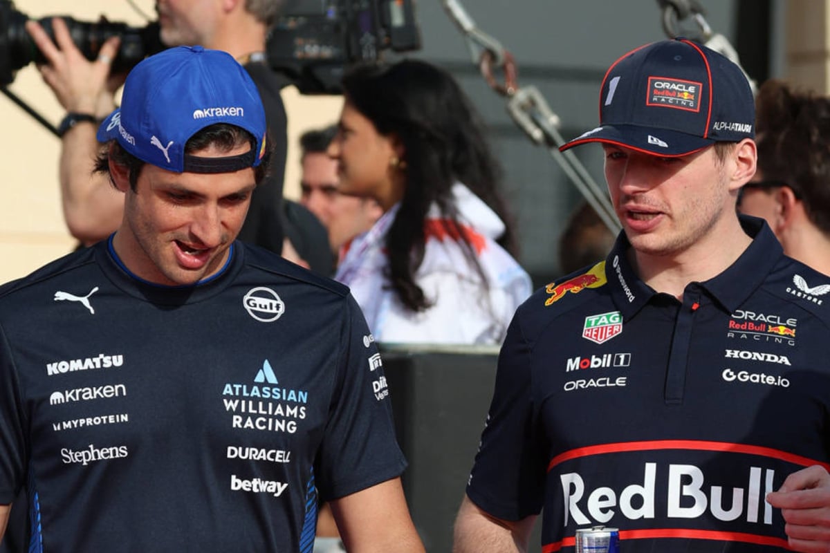 Carlos Sainz and Max Verstappen walking side by side in F1 paddock
