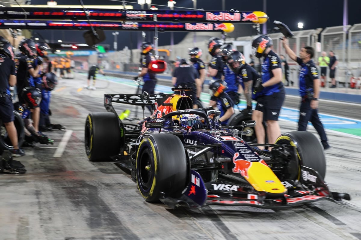 Max Verstappen is serviced by his Red Bull mechanics in the pitlane