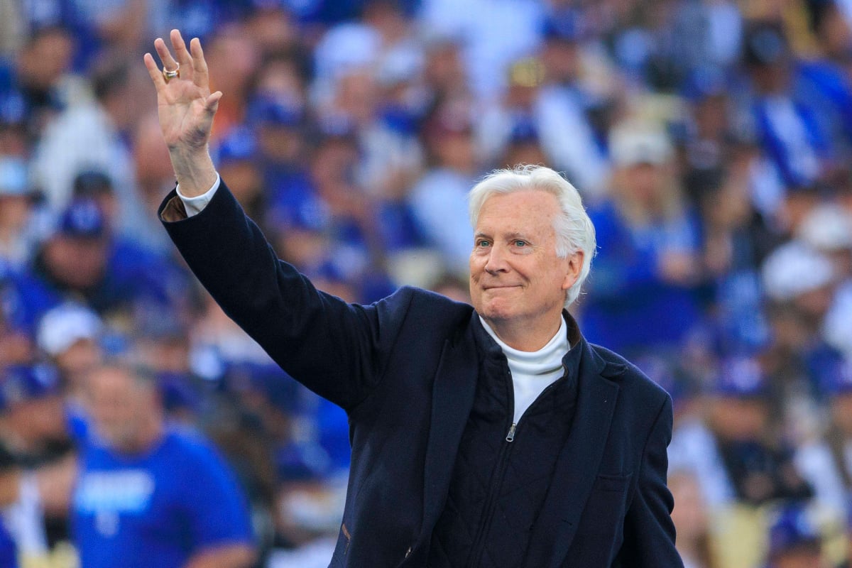 Mark Walter waves to the crowd at an MLB game