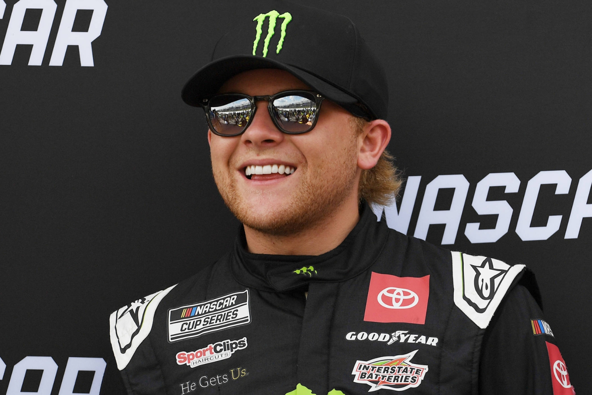 An image of NASCAR driver Ty Gibbs with a huge smile on his face