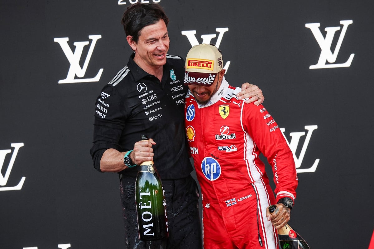 Toto Wolff and Lewis Hamilton embrace on the podium