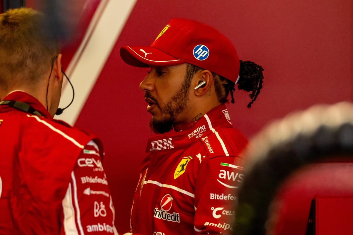Lewis Hamilton in a Ferrari race suit in the Ferrari garage