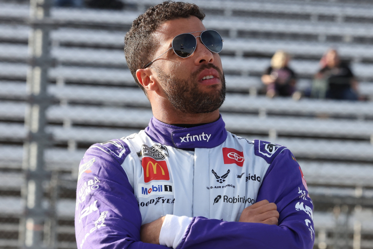 An image of NASCAR driver Bubba Wallace arms crossed pre-race in 2025