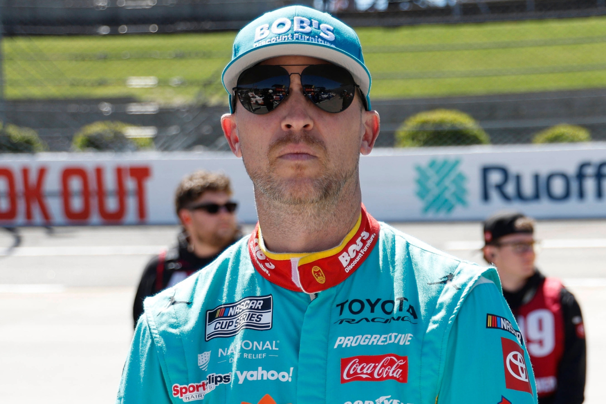An image of Joe Gibbs Racing NASCAR driver Denny Hamlin looking straight-faced on pit road