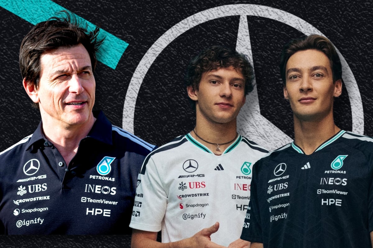 Toto Wolff looks at his drivers George Russell and Kimi Antonelli to a Mercedes logo background