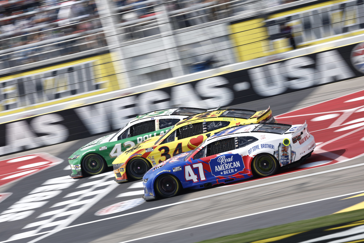 An image of three NASCAR Cup Series cars battling at Las Vegas Motor Speedway