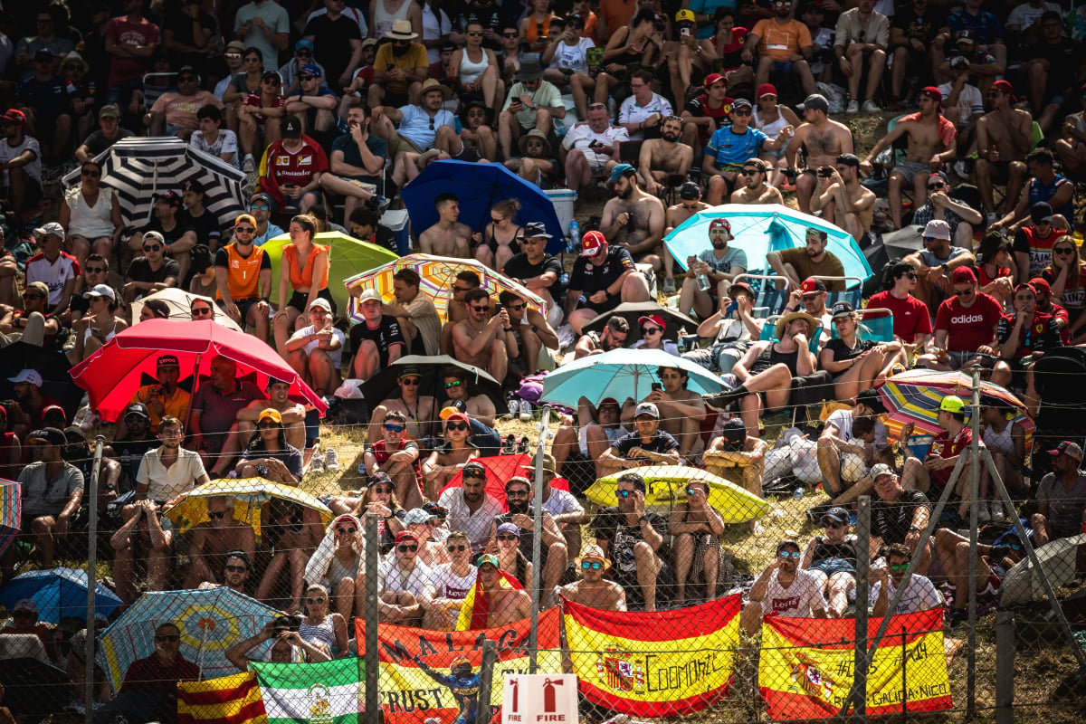F1 fans hide from the sun under umbrellas at the 2022 Barcelona GP