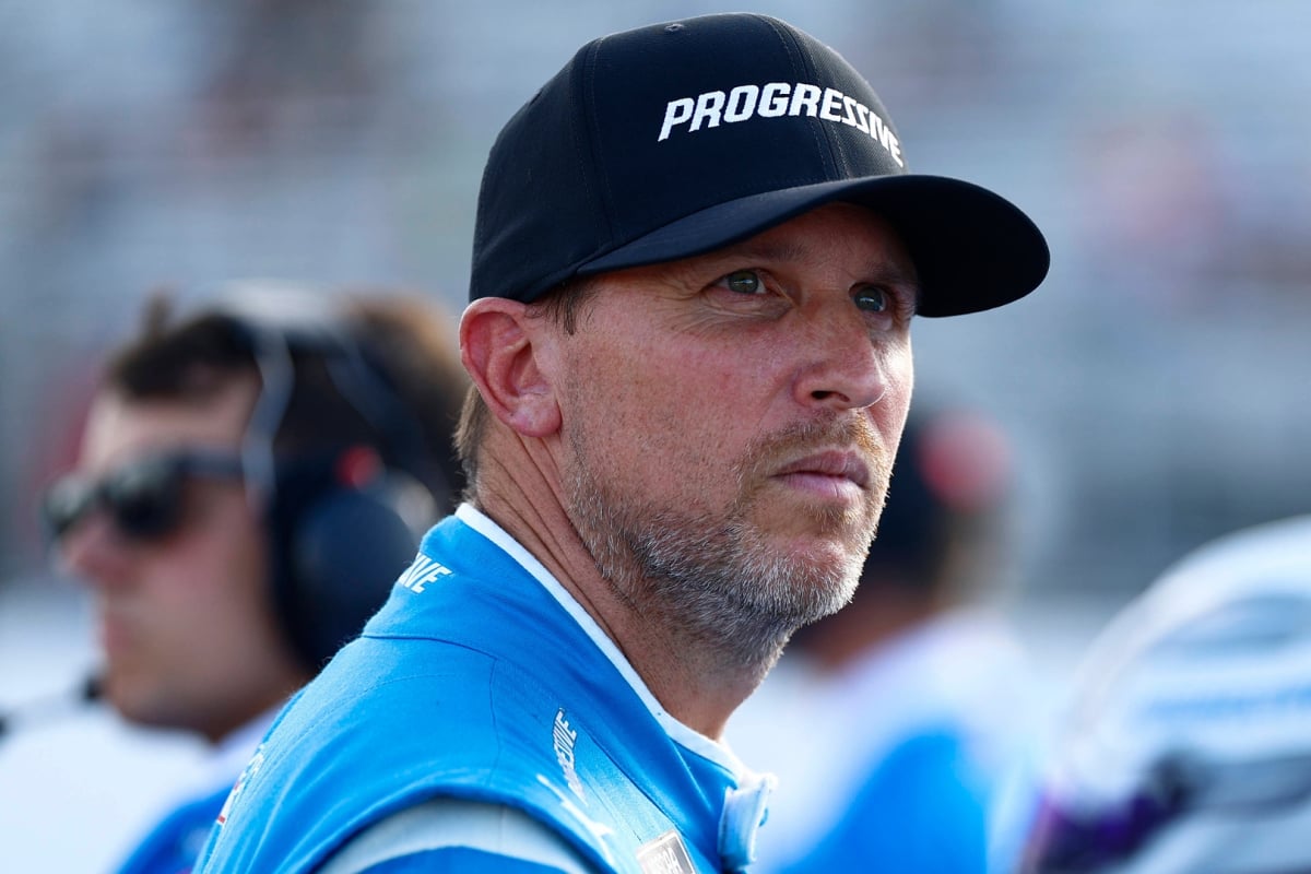 An image of NASCAR driver Denny Hamlin frowning and looking into the distance