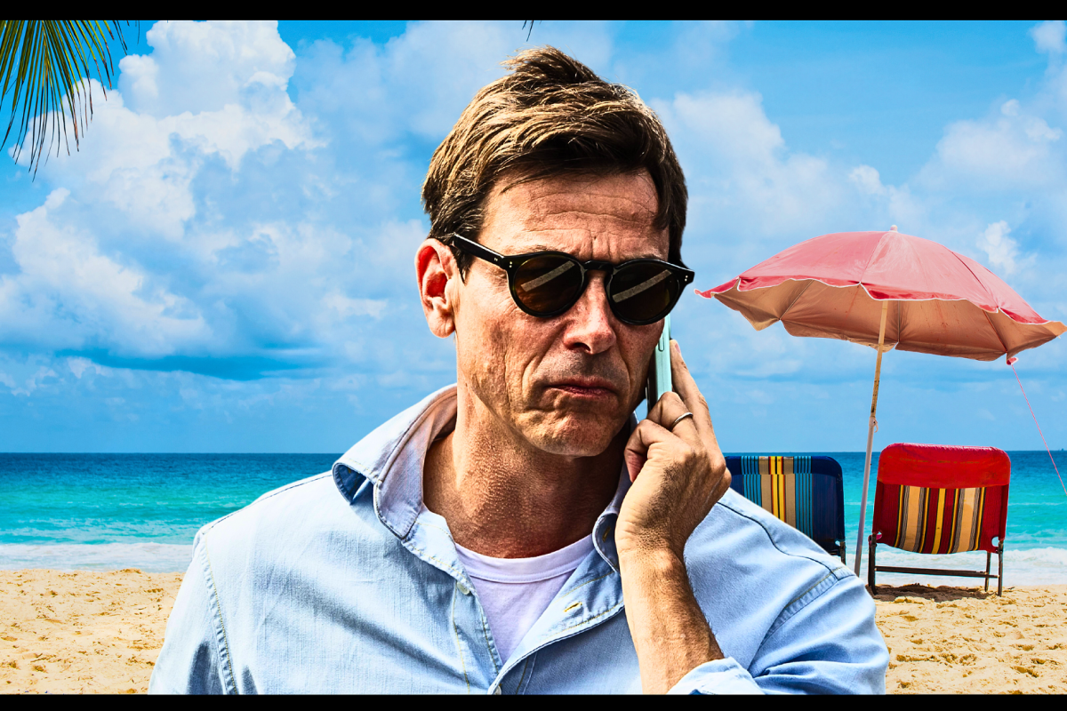 Toto Wolff on the phone in front of a beach-themed background