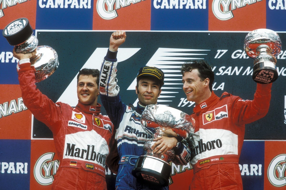Heinz-Harald Frentzen celebrates winning the 1997 San Marino Grand Prix with Michael Schumacher and Eddie Irvine