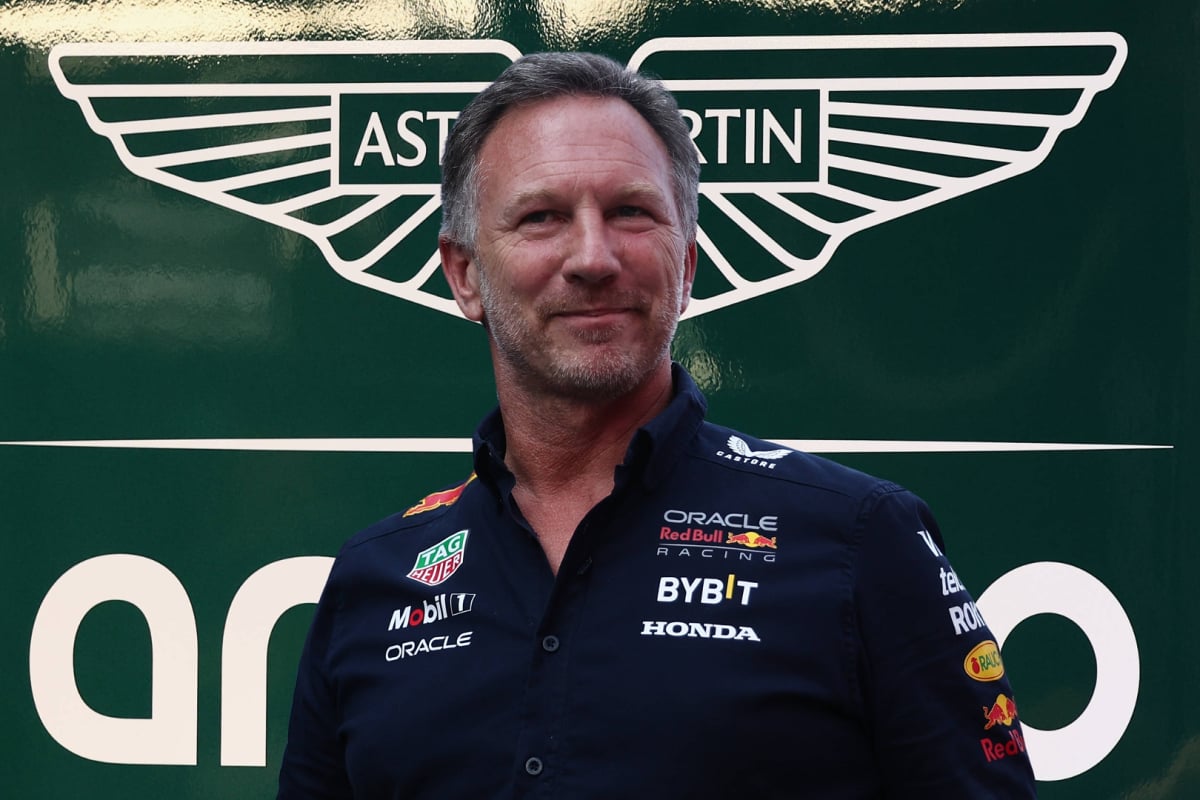Christian Horner in front of the Aston Martin logo
