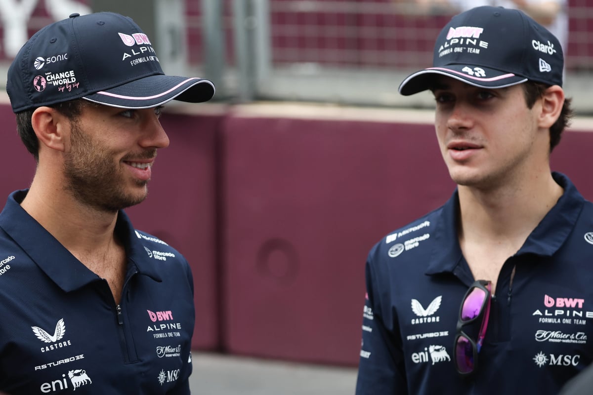 Pierre Gasly smiles at Franco Colapinto as they both stand in their Alpine team gear