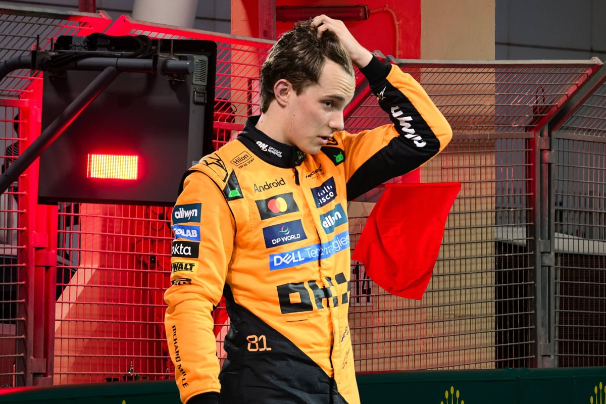 Oscar Piastri looks upset in front of a red flag