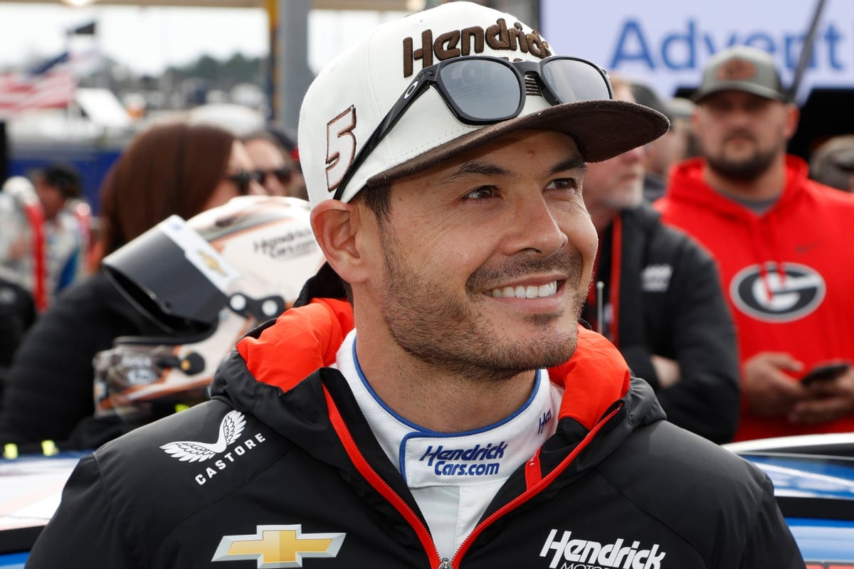An image of Hendrick Motorsports NASCAR star Kyle Larson with a big smile on pit road