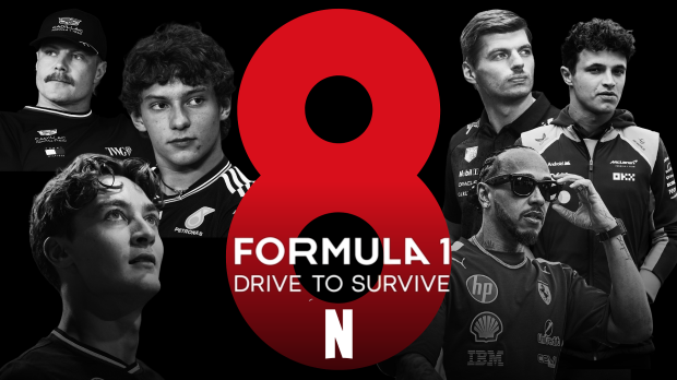 F1 drivers surround a sign showing the eighth season of Drive to Survive
