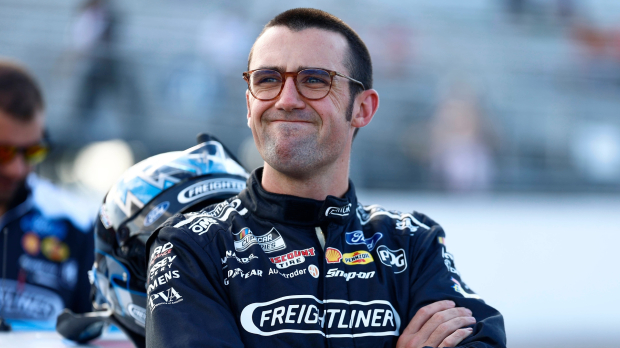 An image of Team Penske NASCAR star Austin Cindric standings with his arms crossed