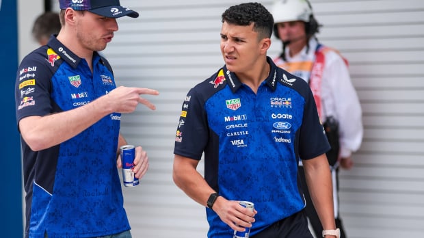 An image of Red Bull F1 drivers Isack Hadjar and Max Verstappen in conversation — Photo: © IMAGO