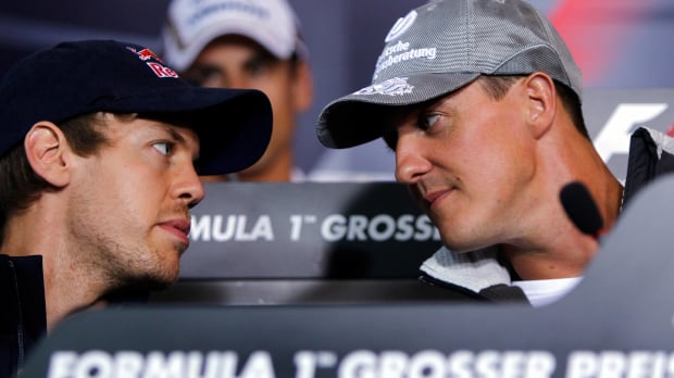 An image of German F1 legends Sebastian Vettel and Michael Schumacher in conversation at a press conference — Photo: © IMAGO