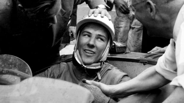 Stirling Moss is congratulated in his car after finishing second in the 1953 Le Mans 24 hours
