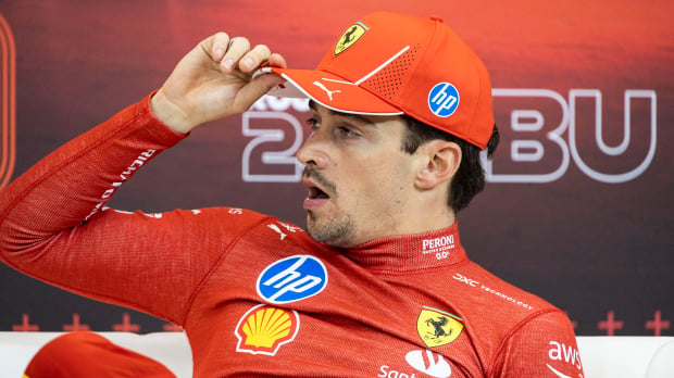 Charles Leclerc yawns at an F1 press conference wearing Ferrari gear — Photo: © IMAGO