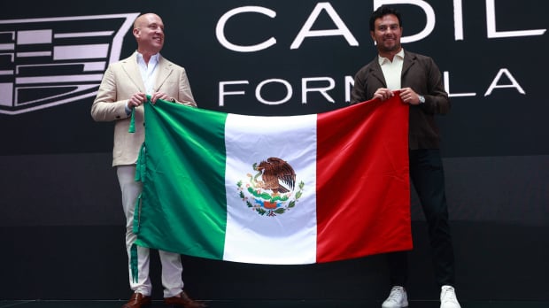 Cadillac F1 CEO Dan Towriss holding Mexican flag with Sergio Perez