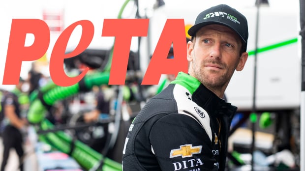 Romain Grosjean in front of the PETA logo — Photo: © IMAGO