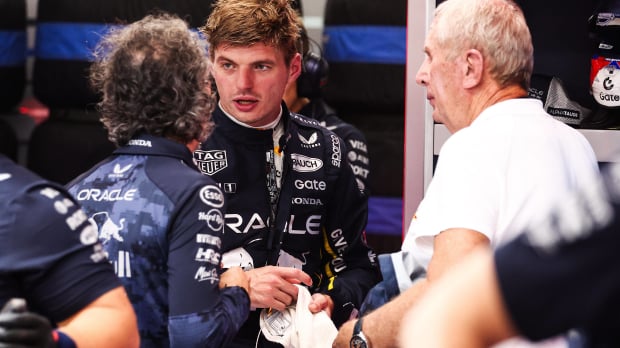 Verstappen, Mekies and Marko discussing in Red Bull garage