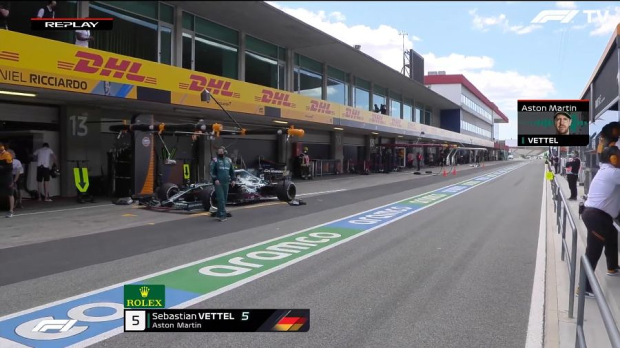 Sebastian Vettel in front of the McLaren garage